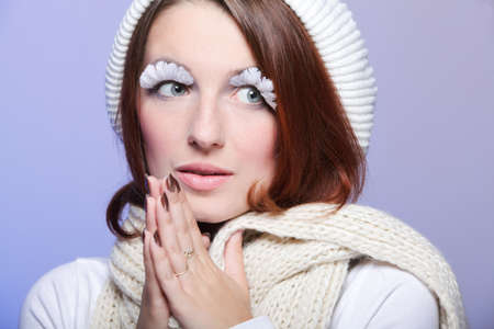 Beautiful winter young woman portrait with white eye-lashes eyelash hat violetの写真素材