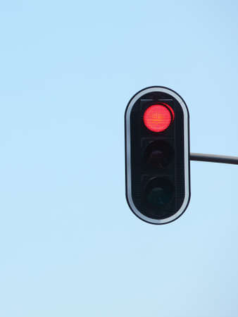 Red traffic lights against blue sky backgroundsの写真素材