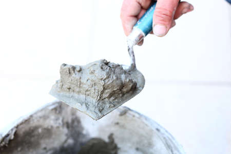 Man Construction worker is tiling at homeの写真素材