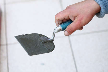 Man Construction worker is tiling at home