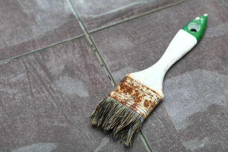 Background Construction tiling at home, tile floor adhesive brush violetの写真素材