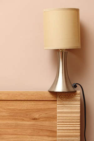 electric lamp on side wooden bed wall backgroundの写真素材