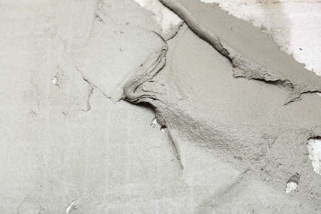 Construction worker is tiling at home, tile floor adhesive Abstract plaster stucco wallの写真素材