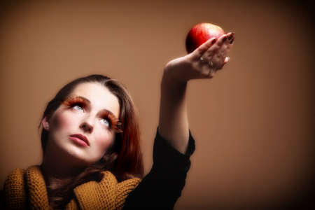 red apple woman in sepia fashion female, fresh girl glamour eye-lashes autumn colourの写真素材