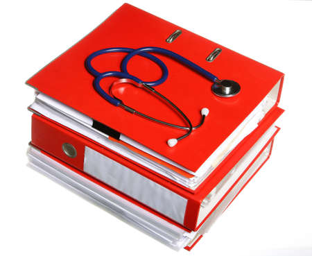stack of red file folders with blue stethoscope on white backgroundの写真素材