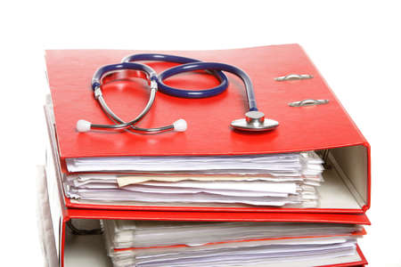 stack of red file folders with blue stethoscope on white backgroundの写真素材
