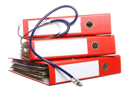 stack of red file folders with blue stethoscope on white backgroundの写真素材