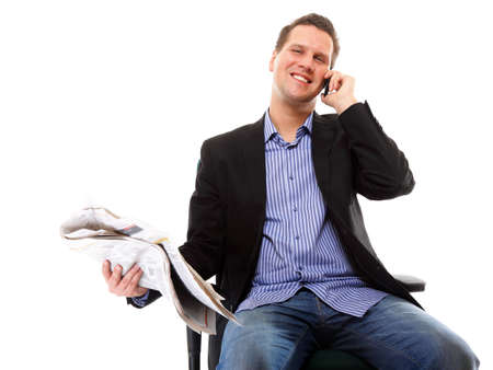 young businessman reads newspaper while phoning  job seeking white backgroundの写真素材
