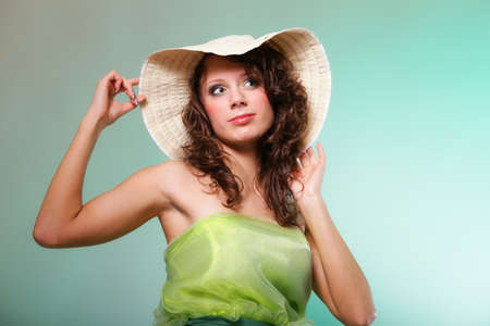 Beautiful smiling spring or summer woman in hat. Green conceptの写真素材