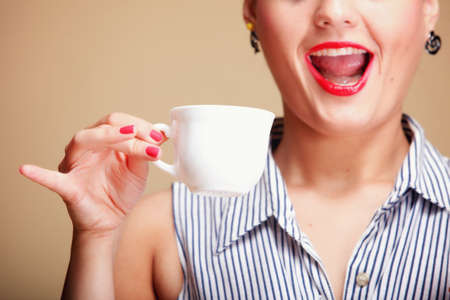  Beautiful Girl Drinking Tea or Coffee. Cup of Hot Beverage brown backgroundの写真素材