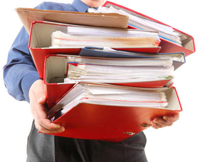 Man holding stack of folders. Pile with old documents and bills. Isolated on white backgroundの写真素材