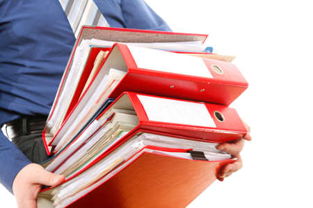 Man holding stack of folders. Pile with old documents and bills. Isolated on white backgroundの写真素材