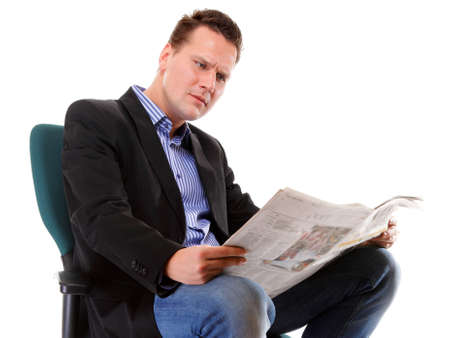 Businessman reading a newspaper isolatedの写真素材