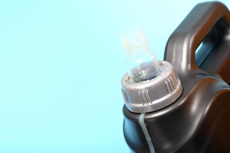 Closeup gray canister with car engine oil blue backgroundの写真素材