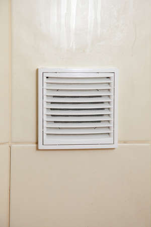 Vent white bathroom ventilation grille in tiled wall