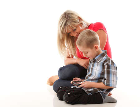 Mother and son playing video game on smartphone isolated on white backgroundの写真素材