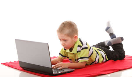 Computer addiction child boy with laptop notebook isolated on white backgroundの写真素材