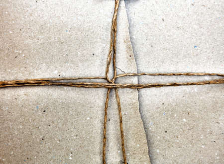 A recycle knot wrapping on gray packing paper backgroundの写真素材