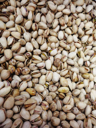 Many shelled pistachios may be used as backgroundの写真素材