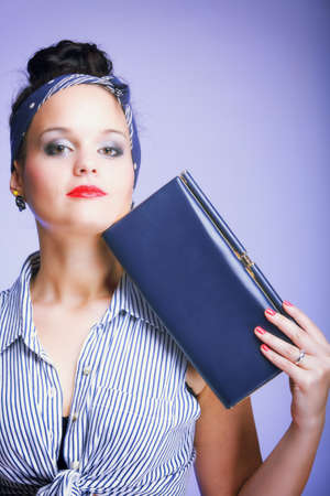 Close-up portrait of young woman with handbag blue background  Fashion photoの写真素材