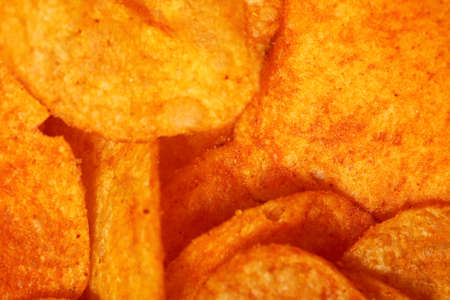 Crisps. Close up potato paprika chips as backgroundの写真素材