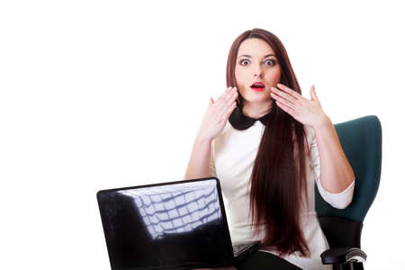 business woman reading bad news at laptop isolated on white backgroundの写真素材