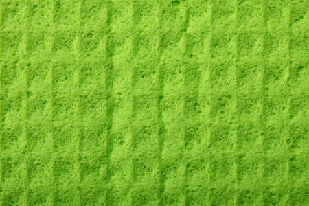 Green kitchen sponge rubber foam as background texture