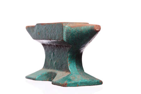 Old rusty heavy steel green anvil  isolated on white backgroundの写真素材