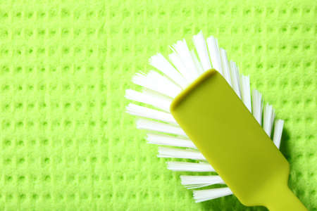 Green sponge background and cleaning brushの写真素材