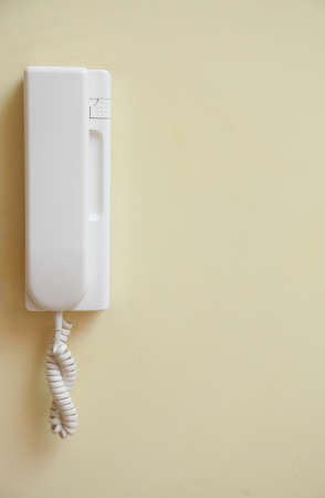 intercom home hung on yellow wall. An object of homeの写真素材