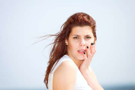 Closeup portrait of beautiful young woman resting at beach in summerの写真素材