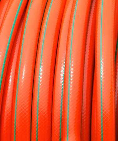  rolled up of orange plastic hose industrial detail as background textureの写真素材