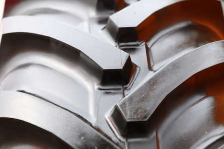 Detailed view of heavy vehicle rubber tire tread texture of a new tractor or other construction machineryの写真素材