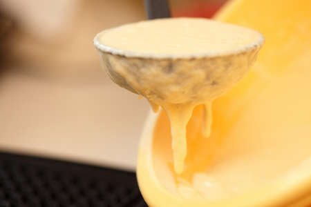 Waffle iron in the kitchen. Preparing homemade waffles, pouring a doughの写真素材