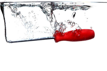 Red screwdriver tool in the water splash over white backgroundの写真素材