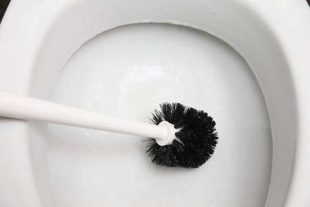 cleaning a toilet bowl with brush. Clean up your house.の写真素材