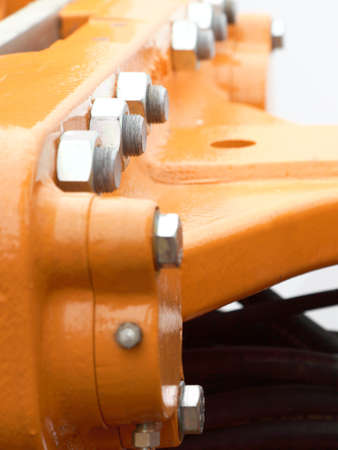 Screws and bolts on orange machine detail of industrial machineryの写真素材