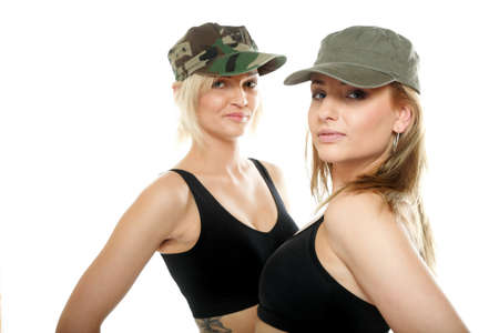 Two sporty women in military caps isolated on white background.の写真素材