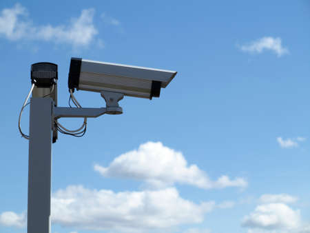 Security camera CCTV video surveillance over blue sky