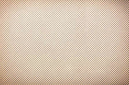 perforated beige textile pattern texture background or backdrop