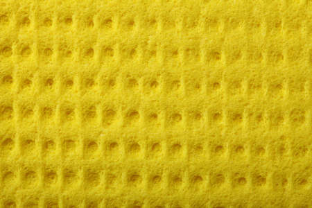 Yellow kitchen sponge rubber foam as background textureの写真素材