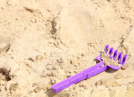 Children's beach plastic toys on sandの写真素材