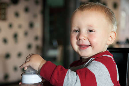 Closeup portrait of cheerful little boy smiling indoor