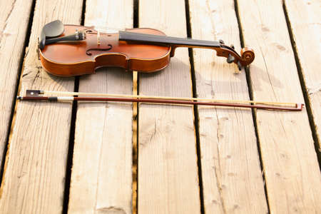 Violin and string on wooden pier. Love of music conceptの写真素材