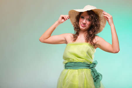 Beautiful smiling spring or summer woman in hat. Green conceptの写真素材