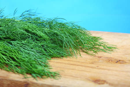 bunch fresh green dill herb on wooden old tableの写真素材