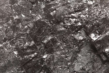 Black hard bituminous coal, carbon nugget closeup macro texture background. Power and energy source.の写真素材