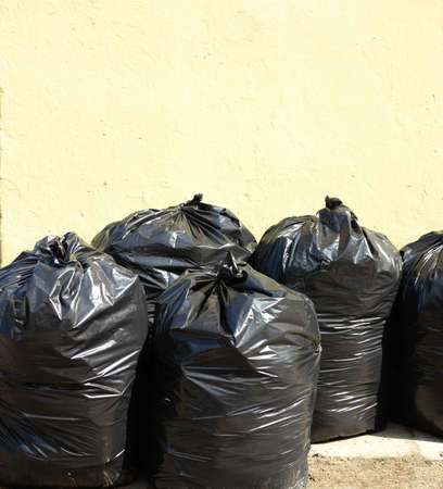 Pile of full black garbage bags outdoor