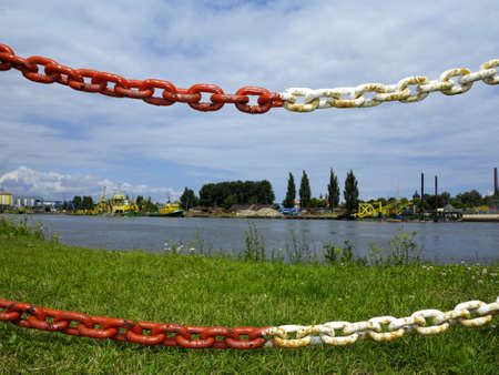 metal chain in foreground defending the industries