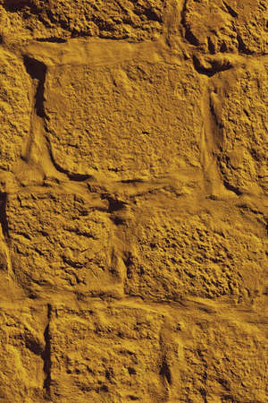 Close up yellow paint uneven old concrete wall background or texture